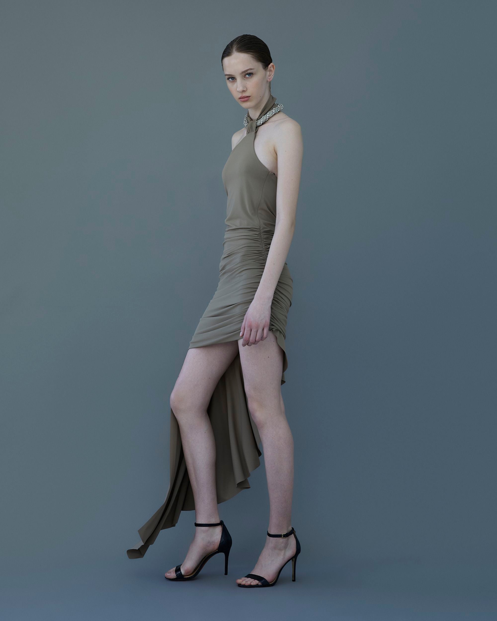 Dark taupe draped jersey dress with ruched detailing and crystal torchon neckline, front view.