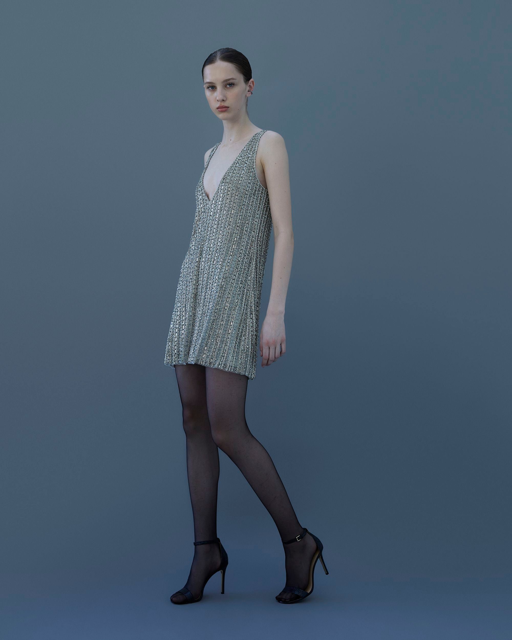 Silver mini dress with jewel embroidery and deep V-neckline – front view.