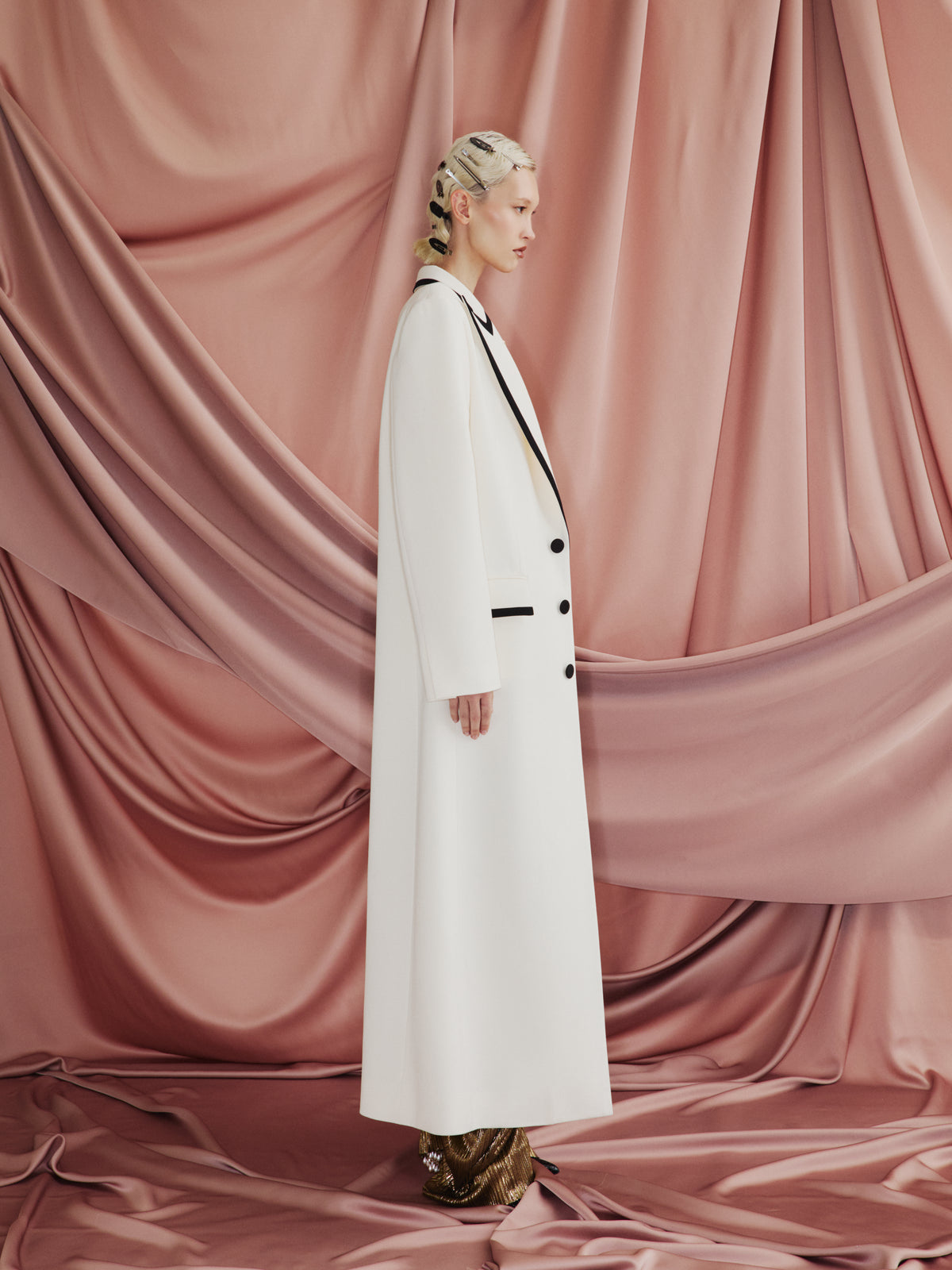 AMEN black wool gabardine long coat with tonal satin trim, peak lapels and covered buttons